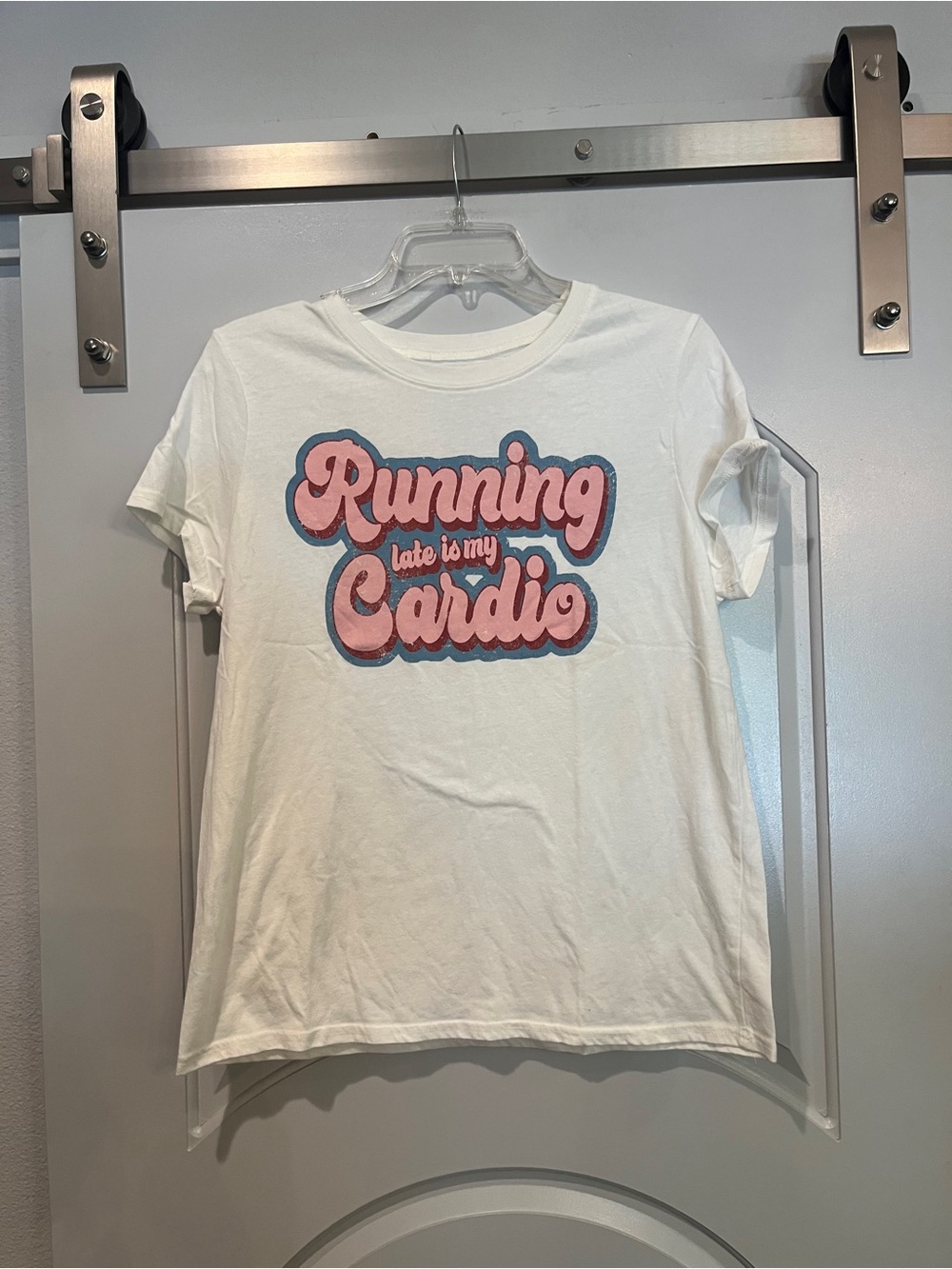 Sold Cream & pink “Running late is my cardio” graphic T-shirt.